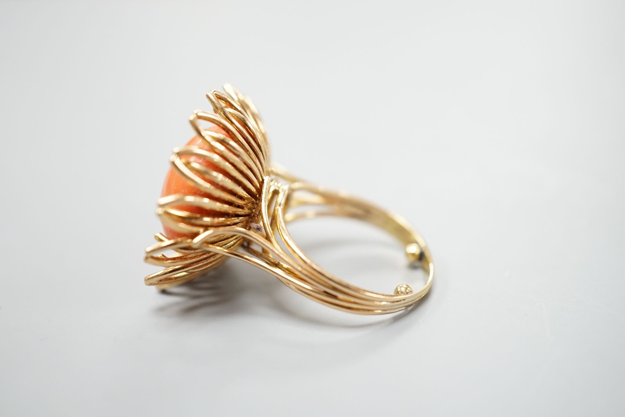 A modern yellow metal and button shaped coral bead set dress ring, size L, gross weight 13.4 grams.